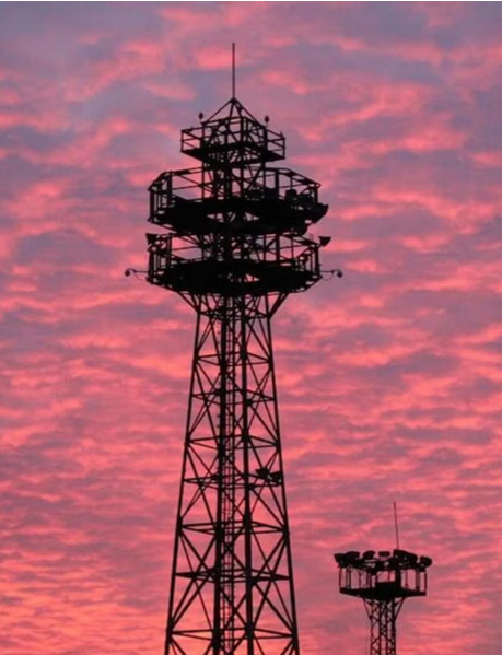 Telecom tower against a sunset sky symbolizing network infrastructure